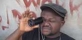<i>Nollywood Babylon.</i> 2008. Canada/Nigeria. Written, directed, and photographed by Ben Addelman, Samir Mallal. Pictured: Lancelot prepares to take a shot. Photo credit: Samir Mallal. &copy; 2008 National Film Board of Canada. All rights reserved