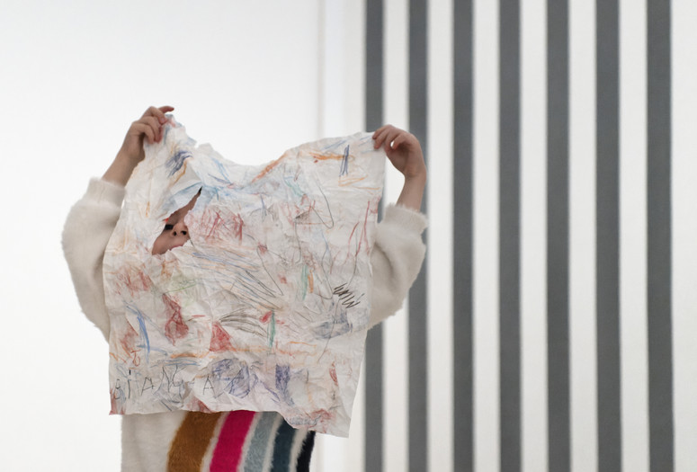 Photo: Martin Seck Image description: A child participates in an activity during a Family Gallery Talk