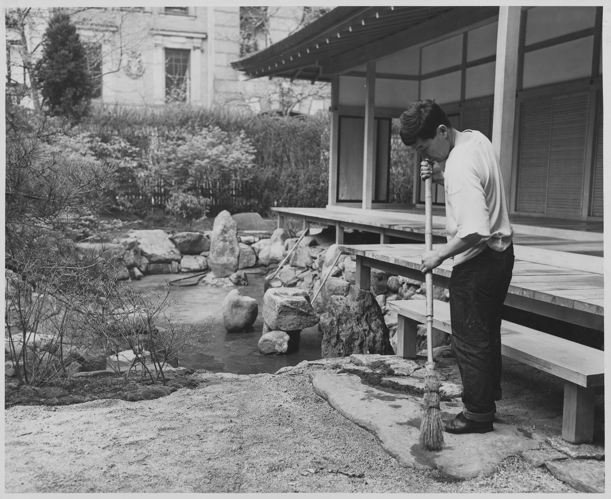 Reconditioning The Japanese House In The Museum Of Modern Art Garden Robert Kobayashi Sweeping The Stones In The Garden Of The House Publicity Photograph Released In Connection With The Exhibition Japanese