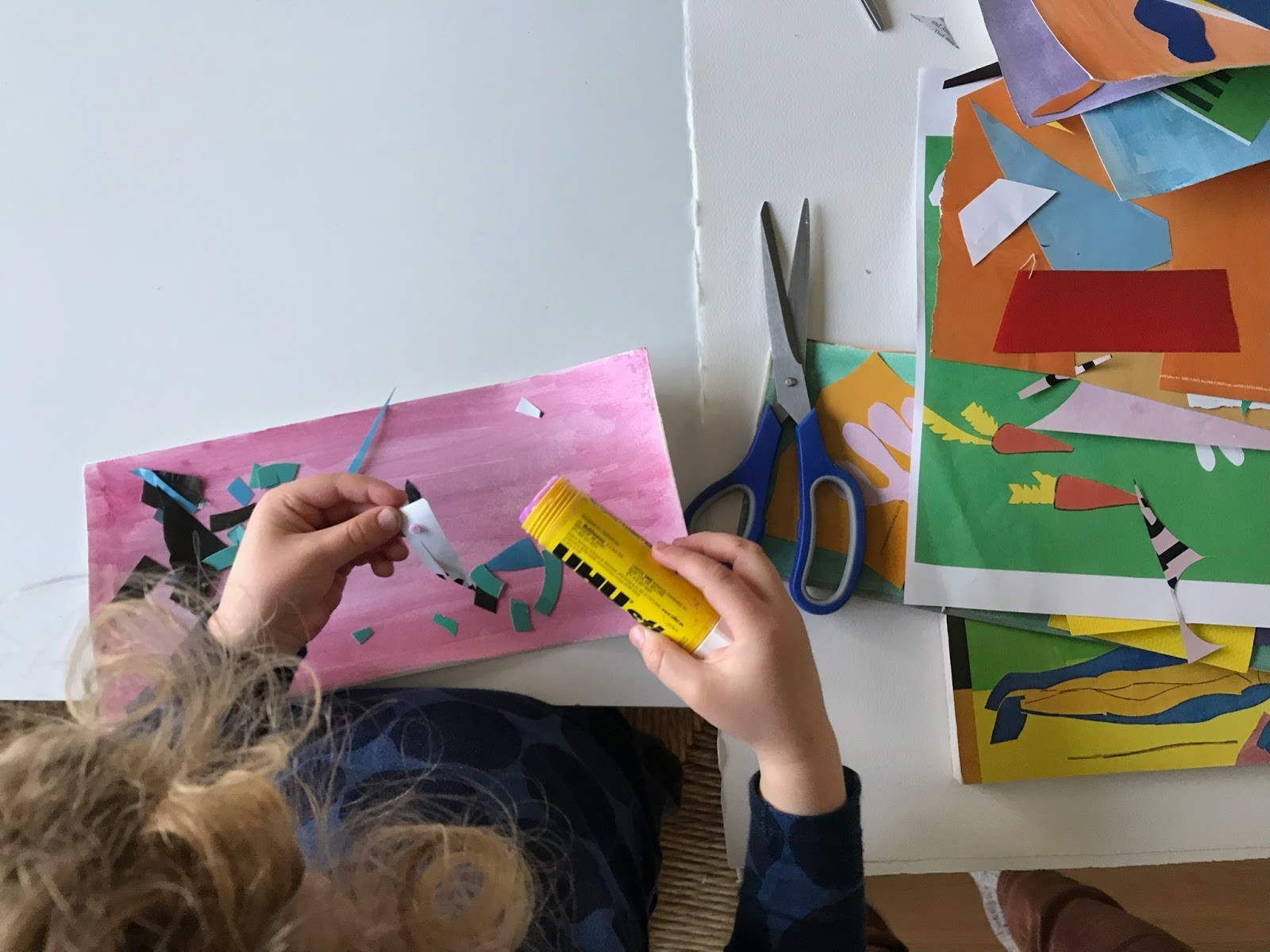 Overhead view of a child making a Matisse-inspired cutout. Photo: Sarah Kennedy