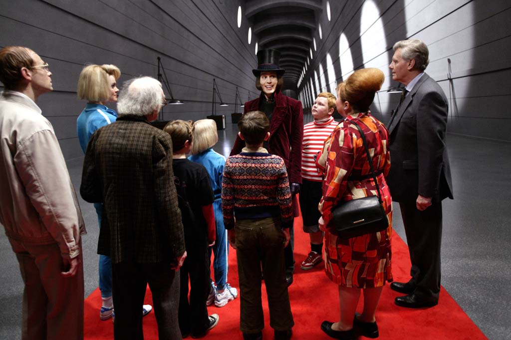 From left to right: Adam Godley, Missi Pyle, David Kelly, Jordan Fry, Annasophia Robb, Freddie Highmore, Johnny Depp, Philip Wiegratz, Franziska Troegner, and James Fox in Warner Bros. Pictures’ fantasy adventure <i>Charlie and the Chocolate Factory</i>. USA. 2005. Directed by Tim Burton. Photo by Peter Mountain.