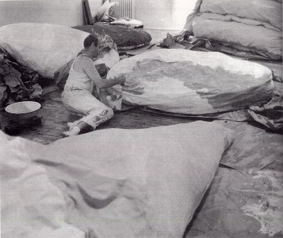 Oldenburg painting his first soft sculptures on the floor of the Green Gallery. Floor Cake can be seen in the background. Image Courtesy of MoMA