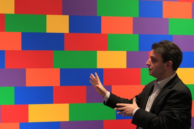Instructor Pablo Helguera in MoMA's galleries. Art featured: Sol LeWitt. Wall Drawing #1144, Broken Bands of Color in Four Directions. 2004. Synthetic polymer paint. Given anonymously. © 2013 Sol LeWitt/Artists Rights Society (ARS), New York