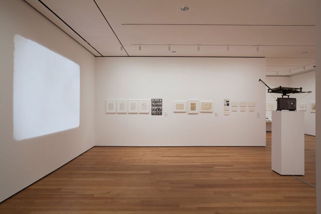 Installation view of There Will Never Be Silence: Scoring John Cage's 4'33". Foreground: Nam June Paik. Zen for Film. 1965. 16mm film leader (silent), 20 min. (approx.). The Museum of Modern Art, New York. The Gilbert and Lila Silverman Fluxus Collection Gift. © 2014 Nam June Paik