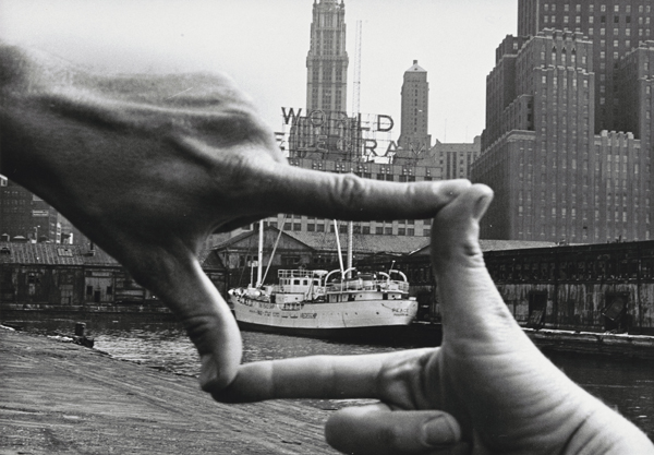 John Baldessari. Hands Framing New York Harbor from Pier 18. 1971. Photograph by Shunk-Kender and János Kender. Gelatin silver print, 7 3/8 × 9 15/16″ (18.8 × 25.2 cm). The Museum of Modern Art, New York. Gift of the Roy Lichtenstein Foundation in honor of Jennifer Winkworth and Kynaston McShine and in memory of Harry Shunk and János Kender. © 2015 John Baldessari. Photograph: Shunk-Kender © J. Paul Getty Trust. The Getty Research Institute, Los Angeles