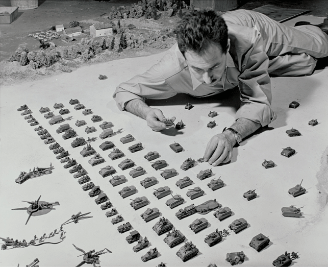 "Sterling silver models of tanks, jeeps, trucks, etc." being  installed during exhibition.    Exhibition Dates:  January 26, 1944 through March 5, 1944.  Photographic  Archive. The Museum of Modern Art Archives, New York.  Photographer, Herbert Gehr