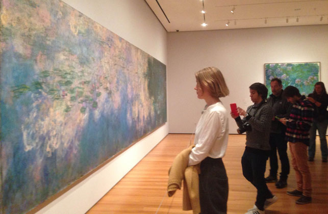 Dianna Molzan in the galleries with Water Lilies. Shown: Claude Monet (French, 1840–1926). Water Lilies. 1914–26. Oil on canvas, three panels, each 6' 6 3/4" x 13' 11 1/4" (200 x 424.8 cm), overall 6' 6 3/4" x 41' 10 3/8" (200 x 1276 cm). Mrs. Simon Guggenheim Fund