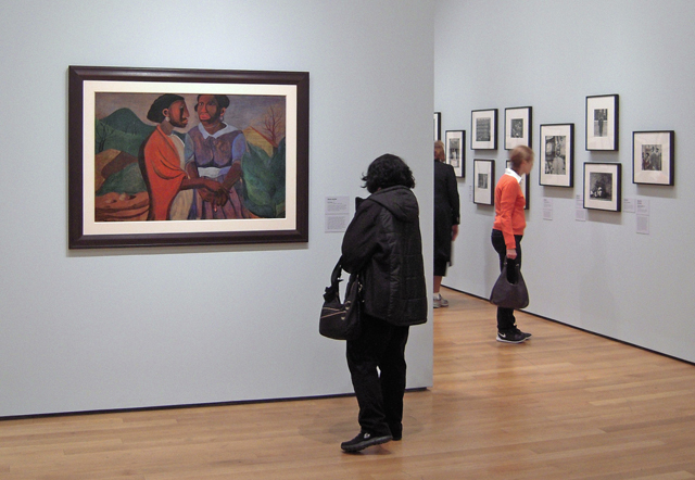 Installation view of Romare Bearden’s The Visitation (1941) in One-Way Ticket: Jacob Lawrence’s Migration Series and Other Visions of the Great Movement North, at The Museum of Modern Art, April 3–September 7, 2015. Photo: TK