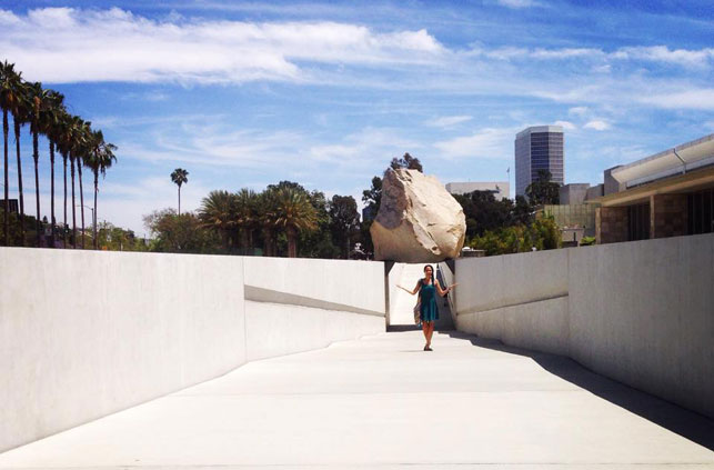 The author poses with Michael Heizer's sculpture Levitated Mass at the Los Angeles County Museum of Art. Photo: Kerri Kearse