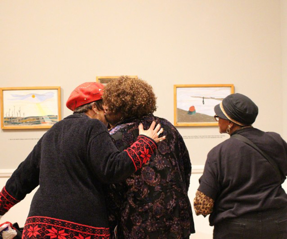 Participants from Elders Share the Arts (ESTA) viewing the exhibition One-Way Ticket: Jacob Lawrence's Migration Series and Other Visions of the Great Movement North