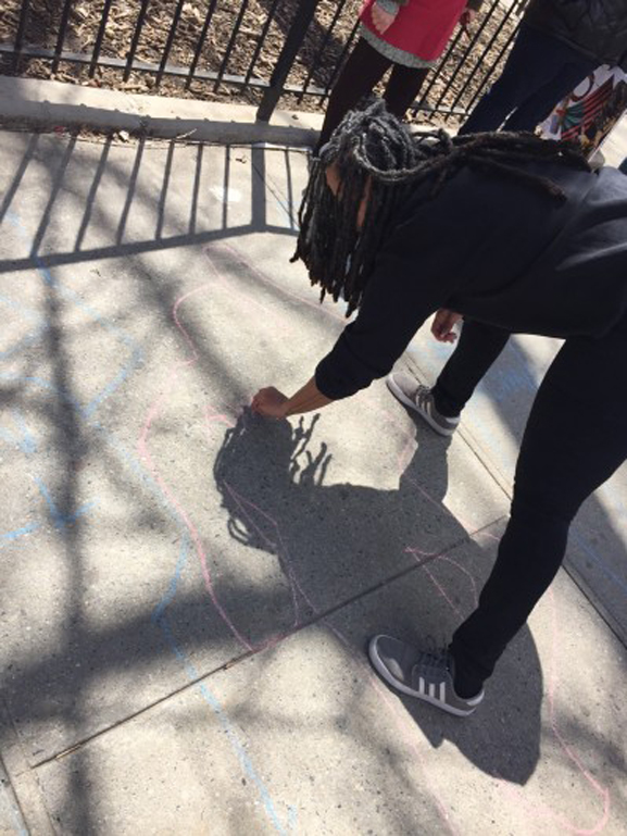 Shellyne and HCFE students create the chalk outlines during their public performance project