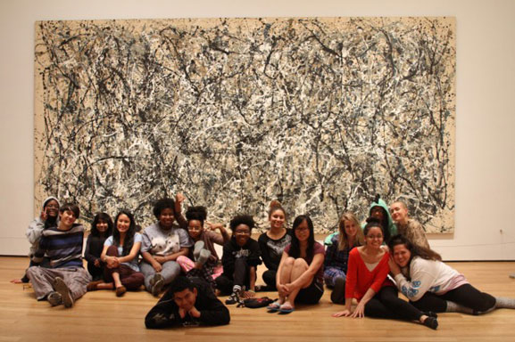 The House of Horrors crew poses in front of a Jackson Pollock. Photo: Calder Zwicky. Shown: Jackson Pollock. One: Number 31, 1950. 1950. Oil and enamel paint on canvas, 8' 10" x 17' 5 5/8" (269.5 x 530.8 cm). Sidney and Harriet Janis Collection Fund (by exchange). © 2015 Pollock-Krasner Foundation/Artists Rights Society (ARS), New York