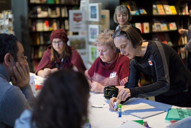 Diane Bertolo, book artist, leads participants in an erasure.