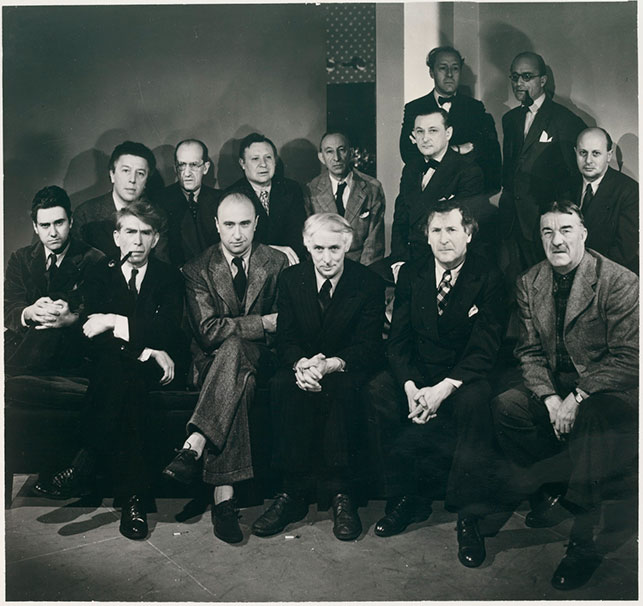 Photograph taken on the occasion of the exhibition Artists in Exile, Pierre Matisse Gallery, New York, March 1942. First row, left to right: Matta Echaurren, Ossip Zadkine, Yves Tanguy, Max Ernst, Marc Chagall, Fernand Léger; second row: André Breton, Piet Mondrian, André Masson, Amédee Ozenfant, Jacques Lipchitz, Pavel Tchelitchew, Kurt Seligmann, Eugene Berman. A number of these artists were aided by the Museum.  Photo: George Platt Lynes. Photographic Archive. The Museum of Modern Art Archives, New York